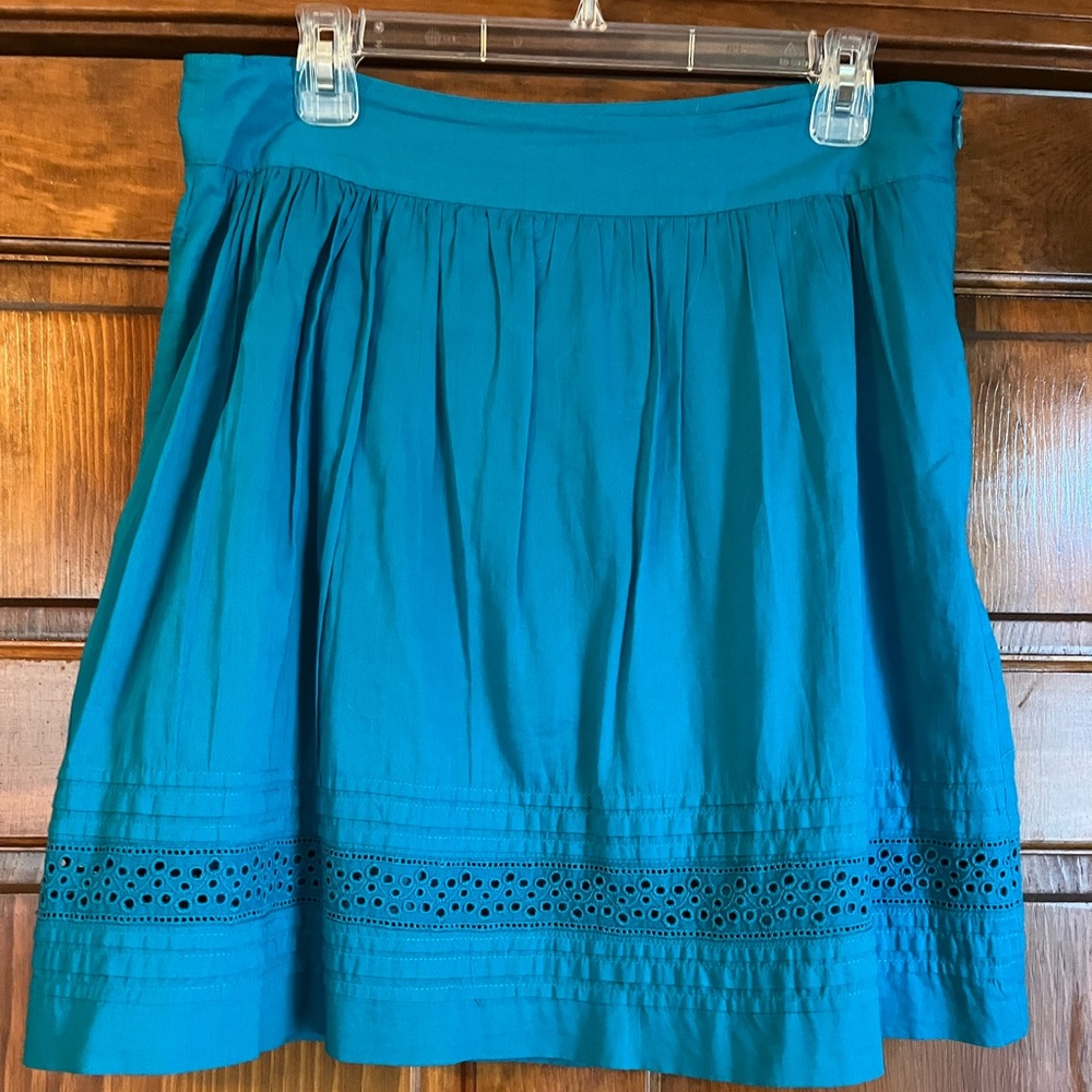 Beachy, turquoise blue eyelet-trimmed mini-skirt perfect is for summer